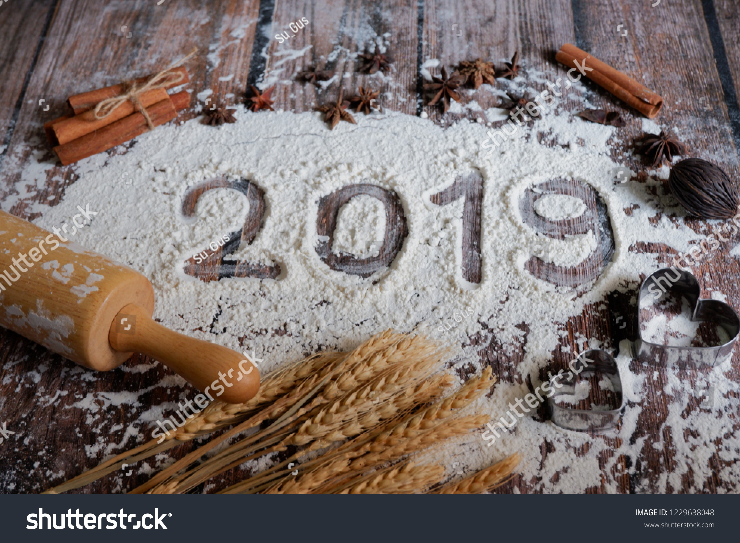 stockphototextmadewithflourwithdecorationsonawooden